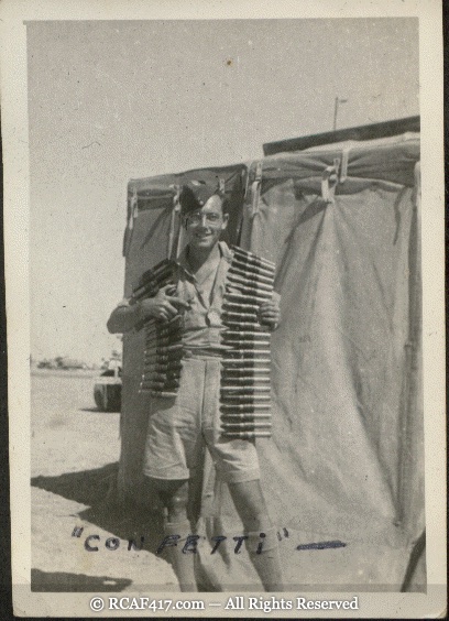 An airman draped in belts of ammunition, captioned 'Confetti'