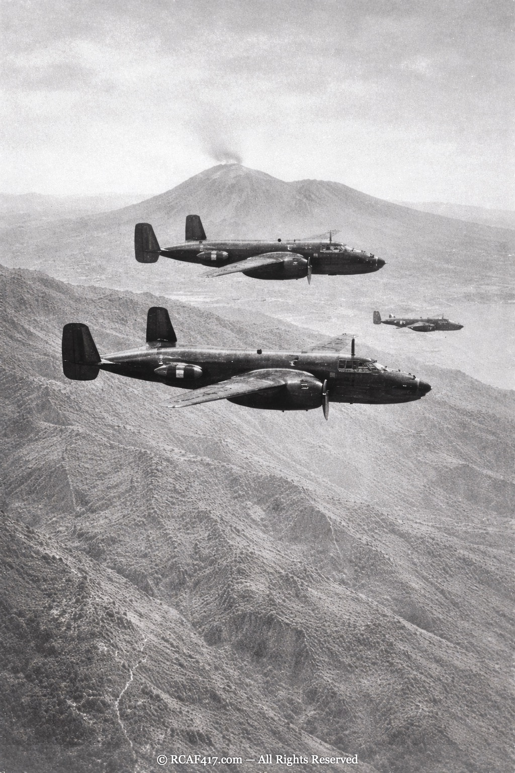 B-25 Mitchells in formation with Mount Vesuvius quiet in the background
