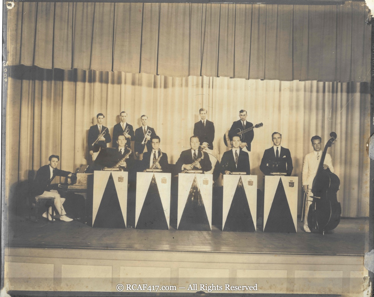 An eleven-piece lineup of Koplitz's orchestra on a theater stage, with saxophone, trumpet, guitar, piano, and bass sections
