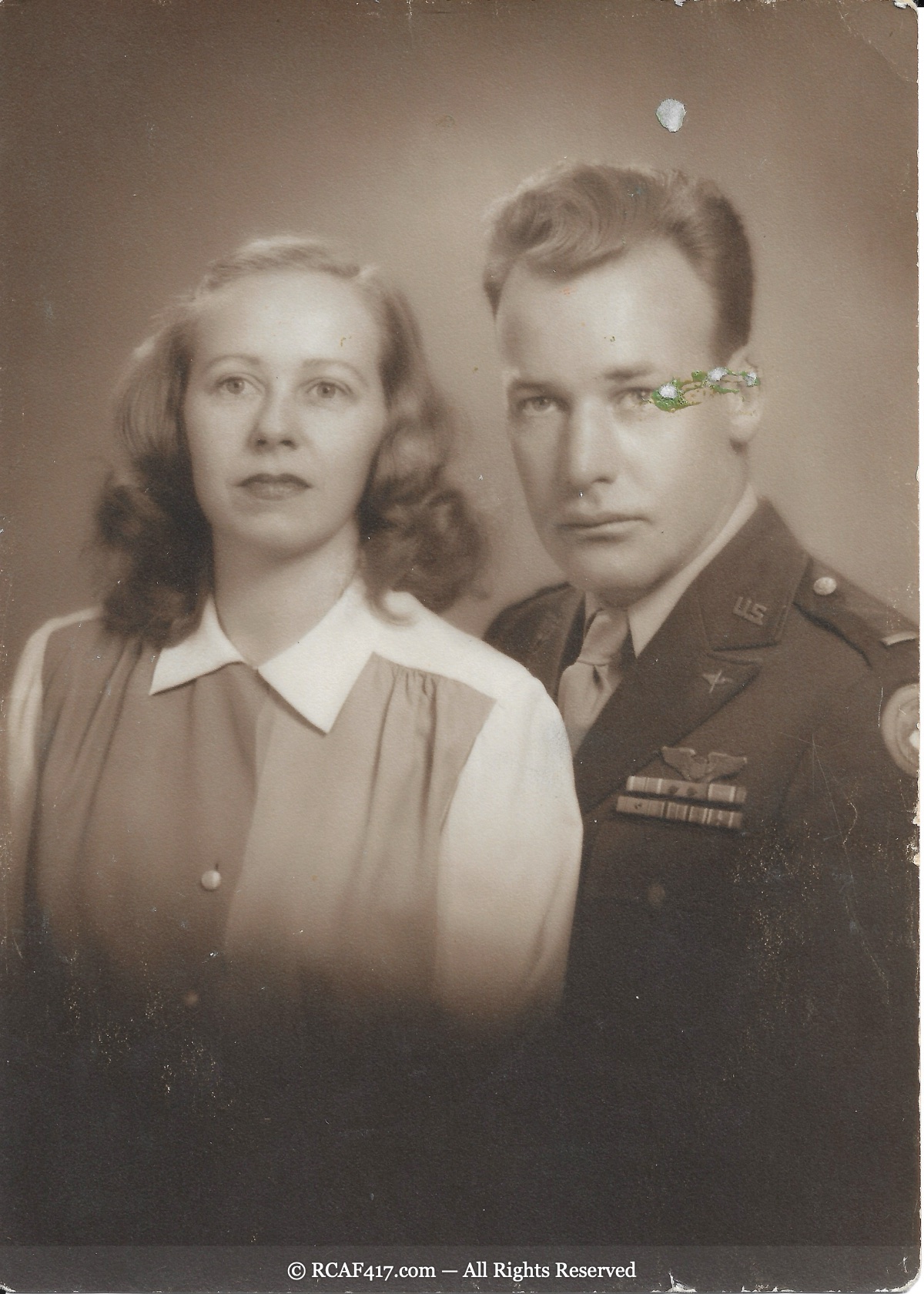 Formal studio portrait of John Francis Koplitz in US Army Air Forces uniform with his first wife